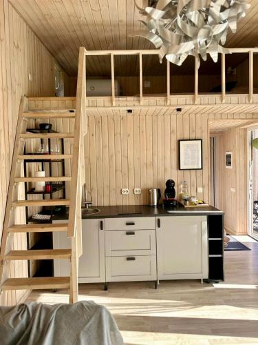 a kitchen with a staircase leading up to a counter at Silazari Klapkalnciems in Klapkalnciems