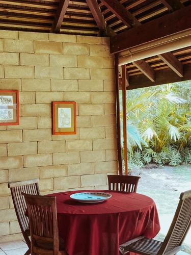 a table with chairs and a plate on top of it at Villa Mitirapa in Tohautu