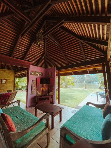 a living room with two beds and a table at Villa Mitirapa in Tohautu