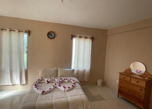 a bedroom with a bed with a heart made up at Arnold's Guest House in San Ignacio