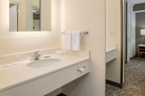 a bathroom with a sink and a mirror at SpringHill Suites Portland Airport in Portland