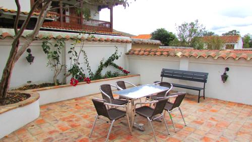 a table and chairs sitting on a patio at Casa La Carolina in Villa de Leyva