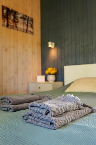 two towels sitting on top of a bed at Silazari Klapkalnciems in Klapkalnciems