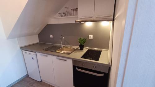a small kitchen with a sink and a stove at PANORAMNA -Guest Rooms in Veliko Tŭrnovo