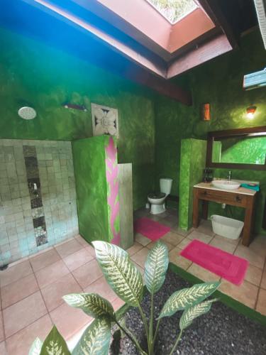 a bathroom with two toilets and a sink at Villa Mitirapa in Tohautu