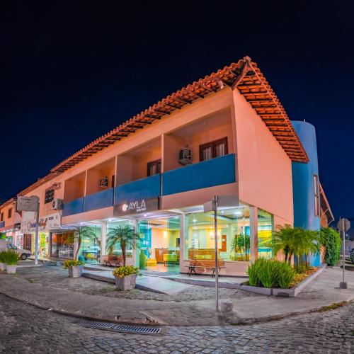 a building in a street at night at Ayla Praia Hotel Centro Porto Segur in Porto Seguro