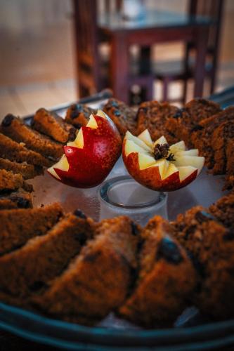 a plate of food with fruit on a table at Ayla Praia Hotel Centro Porto Segur in Porto Seguro