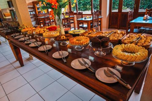 a buffet with many different types of food on a table at Ayla Praia Hotel Centro Porto Segur in Porto Seguro