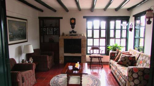 a living room with couches and a fireplace at Casa La Carolina in Villa de Leyva
