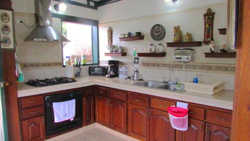 a kitchen with a sink and a stove at Casa La Carolina in Villa de Leyva
