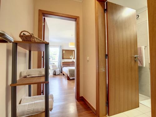 a room with a door leading to a bedroom at Charming Garajau by AH in Caniço