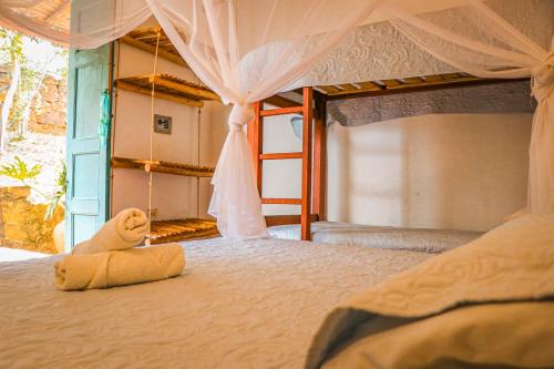 a teddy bear is sitting on top of a bed at Hotel Spa El Cogollo By MH in Barichara