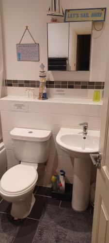 a bathroom with a toilet and a sink at Aylesbury Lovely Double and Single Bedroom with Guest only Bathroom in Buckinghamshire