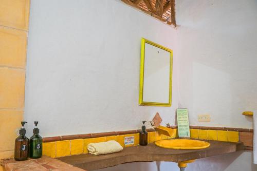 a bathroom with a sink and a mirror on the wall at Hotel Spa El Cogollo By MH in Barichara