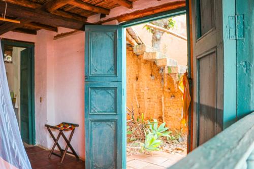 an open door of a house with a window at Hotel Spa El Cogollo By MH in Barichara