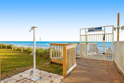 a boardwalk leading to the beach with a street sign at Beach House in Destin