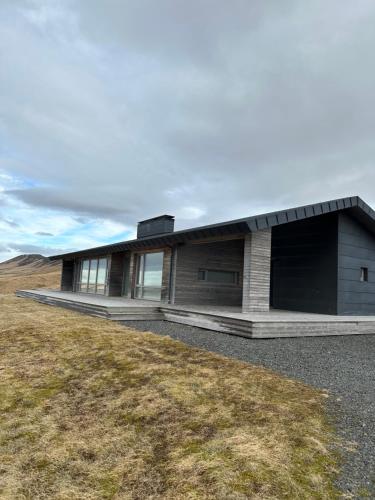 a house on top of a grassy hill at Hekla Adventures in Hvolsvöllur