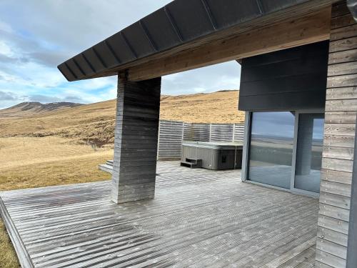 a house with a deck with a view of the ocean at Hekla Adventures in Hvolsvöllur