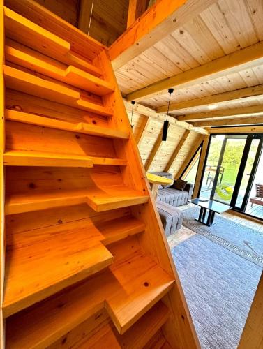 a wooden staircase in a log cabin with a living room at Splav Horizont in Gaočići