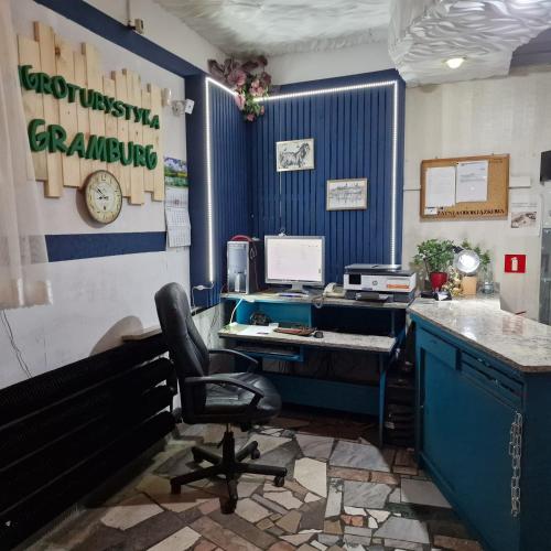 an office with a desk with a computer and a chair at Agroturystyka Gramburg in Zblewo