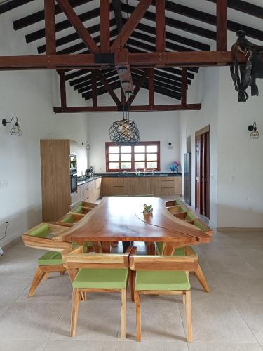 a large kitchen with a wooden table and chairs at Finca Mutatá in Montenegro