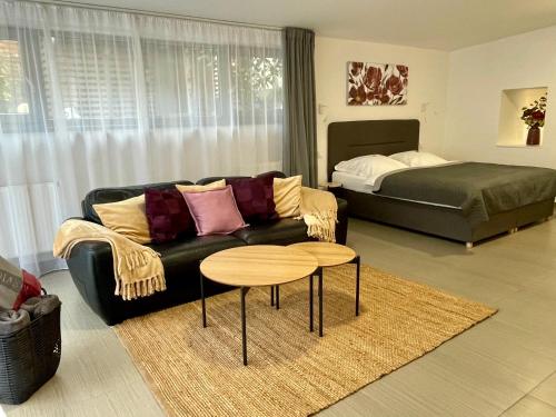 a living room with a couch and a bed at Pension Phoenix in Znojmo