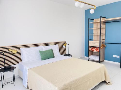 a bedroom with a large bed and a book shelf at Blu Mar Sea View Apartments in St. Paul's Bay