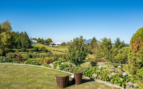 a garden with flowers and plants in a field at Mountviews Lodge in Taupo