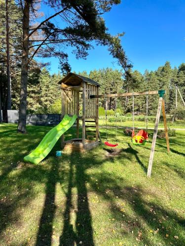 a park with a playground with a slide at Silazari Klapkalnciems in Klapkalnciems