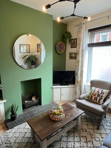 a living room with a table and a mirror at #02 Just the Splott Sleeps 6- 8mins to Stadium - " Perfect for Contractors and Families - Free Parking" in Cardiff