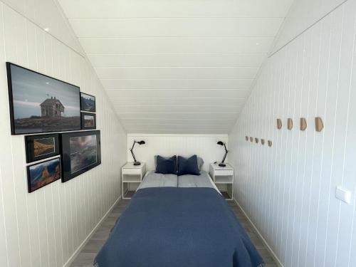 a bedroom with a large bed with two night stands at High standard Lodge Ballstad in Ballstad