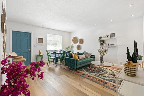 a living room with a green couch and a table at Stylish 2 BR condo - close to Riverwalk in Fort Lauderdale