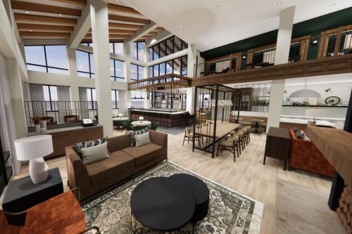 TownePlace Suites by Marriott Avon Vail Valley في آفون: غرفة معيشة كبيرة مع أريكة وطاولة