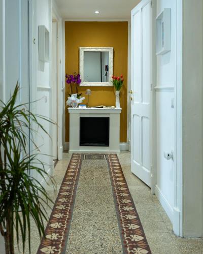 a hallway with a sink and a mirror at Gala Sardinia in Cagliari