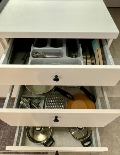 a drawer in a kitchen with dishes and utensils at Pension Phoenix in Znojmo