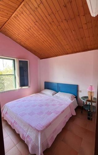 a bedroom with a large bed with a wooden ceiling at Sulla strada del mare in Grosseto