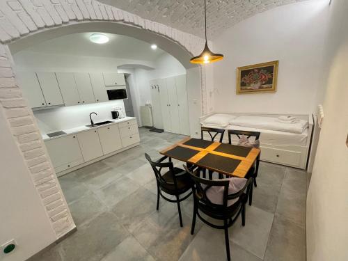 a kitchen and dining room with a table and chairs at Pension Phoenix in Znojmo