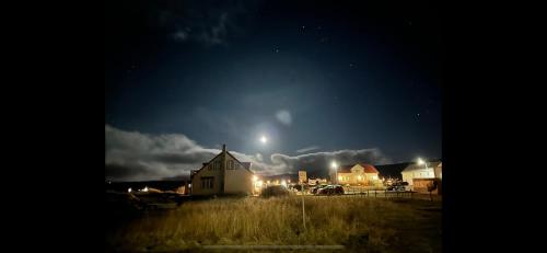 a house with a moon in the sky at night at Brimslóð Atelier Guesthouse in Blönduós