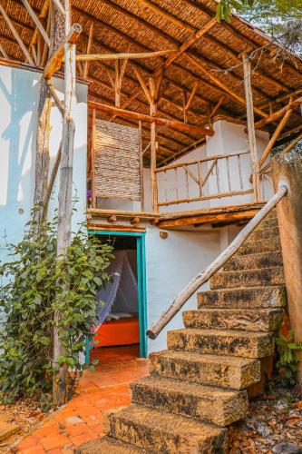 a staircase leading to a house with a roof at Hotel Spa El Cogollo By MH in Barichara