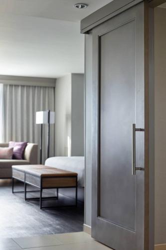 a hotel room with a door leading to a bedroom at Raleigh Marriott City Center in Raleigh