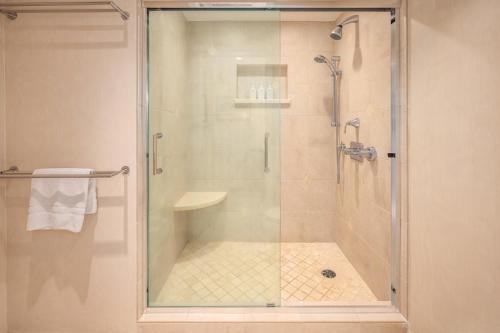 a bathroom with a shower with a glass door at Kaanapali Alii in Lahaina