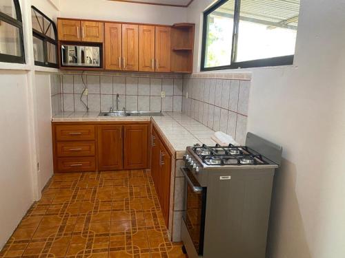 a small kitchen with a stove and a sink at Casas La Chirincoca in San Isidro de El General