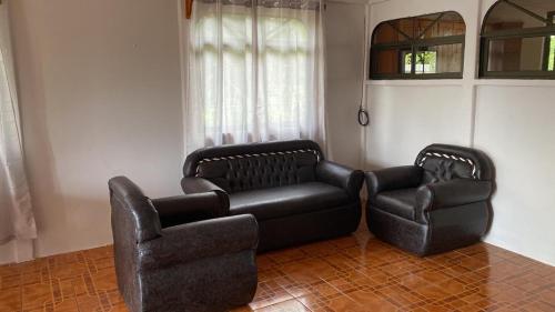 a living room with a couch and a chair at Casas La Chirincoca in San Isidro