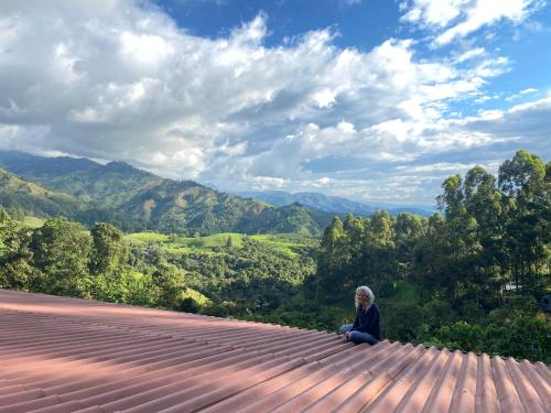 a man sitting on the edge of a roof at Ecoresort Gran Azul in Salento