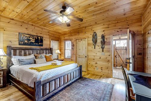 a bedroom with a bed and a ceiling fan at Cabin In The Sky in Epworth