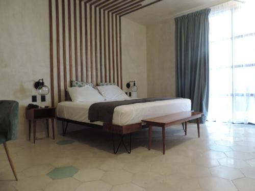 een slaapkamer met een groot bed en een tafel bij Dorados Conventions & Resort in Oaxtepec