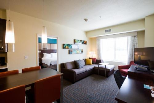 a hotel room with a couch and a bed at Residence Inn by Marriott Oklahoma City Northwest in Oklahoma City