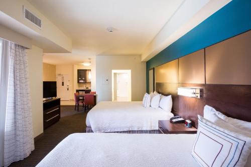 a hotel room with two beds and a desk at Residence Inn by Marriott Oklahoma City Northwest in Oklahoma City