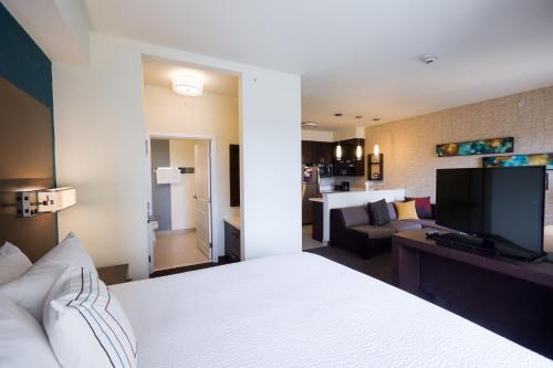 a hotel room with a bed and a living room at Residence Inn by Marriott Oklahoma City Northwest in Oklahoma City