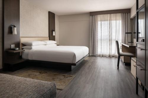 a hotel room with two beds and a desk at Marriott Riverside at the Convention Center in Riverside